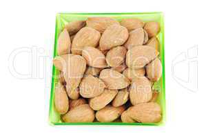 Bunch of almond nuts on a green cup