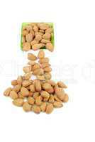 Scattered almond nuts on a cup sliding down