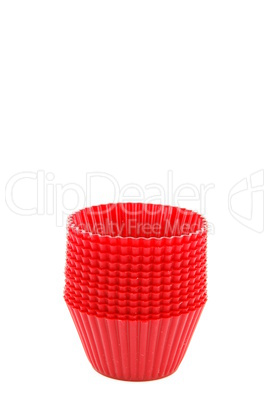 Red plastic cups for small cakes on white