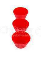 Red plastic cups for small cakes on white