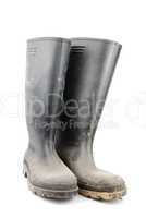 Pair of black rubber boots on white