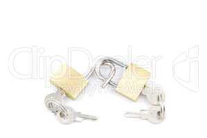 Two golden padlocks and keys on white