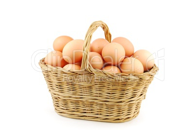 Eggs in a wicker basket on white