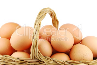 Close-up of eggs in a wicker basket on white