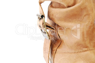 Close-up of a women leather brown boot on white