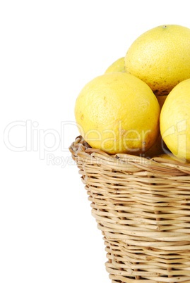 Close-up of lemons in a wicker basket on white