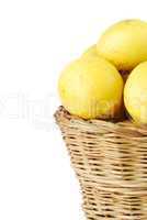 Close-up of lemons in a wicker basket on white