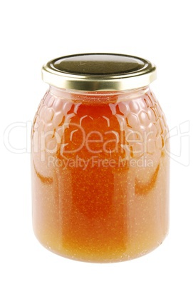 Homemade honey in a glass jar on white