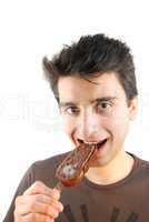 Portrait of a cute young man eating an ice-cream