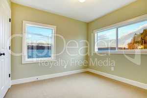 Empty new bedroom with water view, green walls.