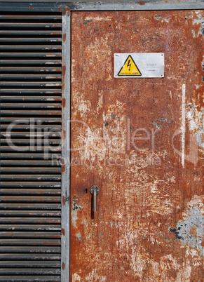 High voltage sign on a rusty door