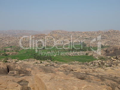 Green fields surrounded by granite boulders,