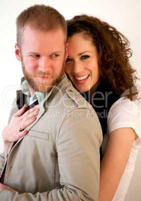 Beautiful young happy couple hugging and flirting.