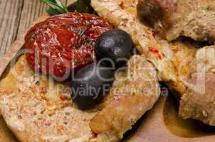 Baked meat with olives and roasted tomatoes