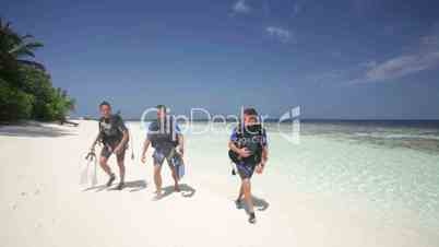 divers walking on island