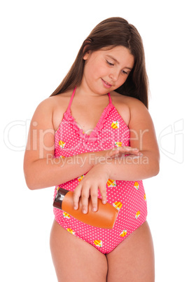 Girl in swimsuit applying sun lotion