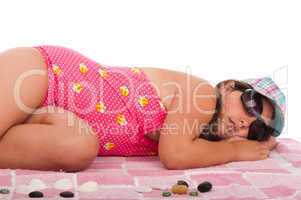 Girl in swimsuit sleeping at the beach