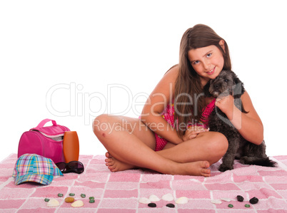 Girl in swimsuit at the beach with dog