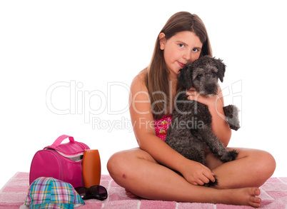 Girl in swimsuit at the beach with dog