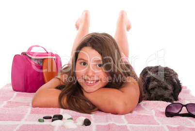 Girl in swimsuit at the beach with dog