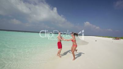 young couple having fun on deserted island