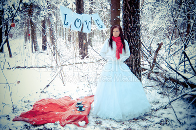 Girl with red scarf in white snow forest with love.