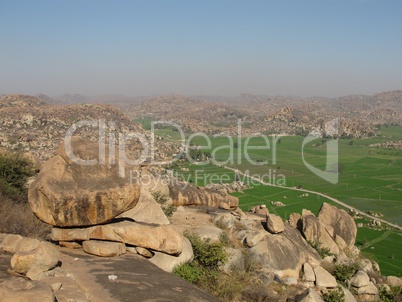 Balancing granite boulder and rice fields