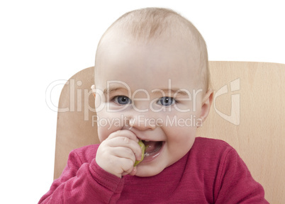 child in red shirt eating