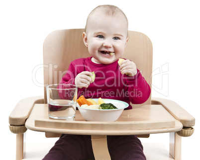 young child eating in high chair