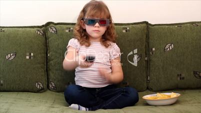 little girl with 3d glasses watching tv