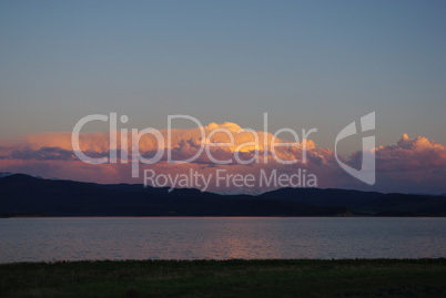 Lake, high mountains and clouds at sunrise, Montana