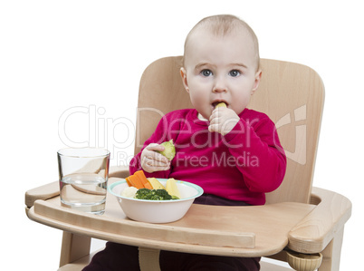 young child eating in high chair