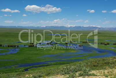 Blue River on high plains with snowy mountain range, Colorado