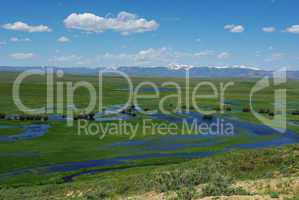 Blue River on high plains with snowy mountain range, Colorado