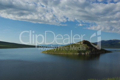 Beautiful green island and high mountain range, Clark Canyon reservoir, Montana