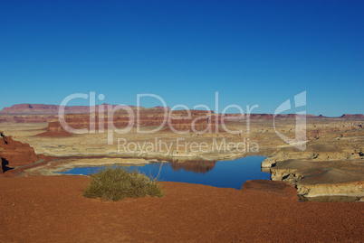 View of Colorado River with red mountains and bridge from Hite overlook, Utah