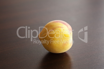 Peach lying on a wooden table