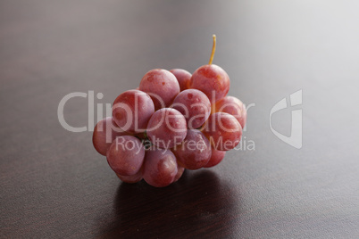 bunch of grapes lying on a wooden table