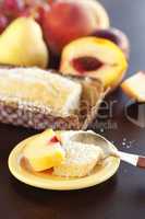 peach, pear, plum, coconut cake,spoon and grapes on a wooden tab