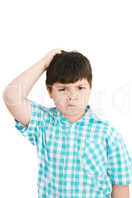 Boy scratches his head in puzzlement or confusion, as if ponderi
