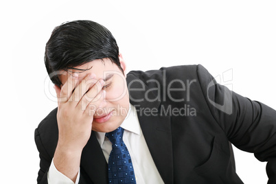 Portrait of a young business man depressed from work against whi