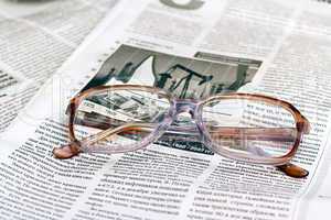 reading glasses lying on a newspaper