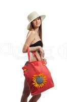 Yong girl walk with red beach bag and straw hat