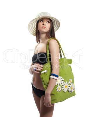 Beauty girl in black bikini with green beach bag