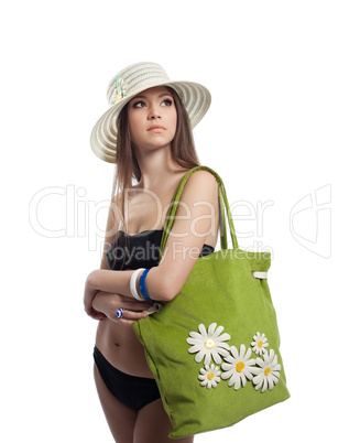 Yong woman portrait in straw hat with bag