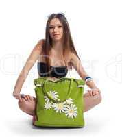 Yong woman posing with green beach bag isolated