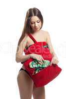 Woman take slippers from red beach bag isolated