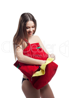 Woman put towel in red beach bag isolated