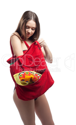 Woman search towel in red beach bag isolated