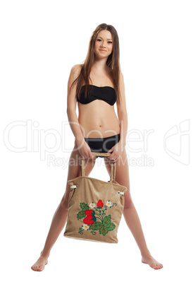 girl in black bikini stand with funny beach bag